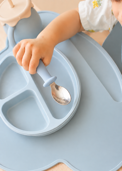 子どもがスプーンで離乳食をすくっている使用イメージ。丸みのあるシリコングリップを手で握っている様子