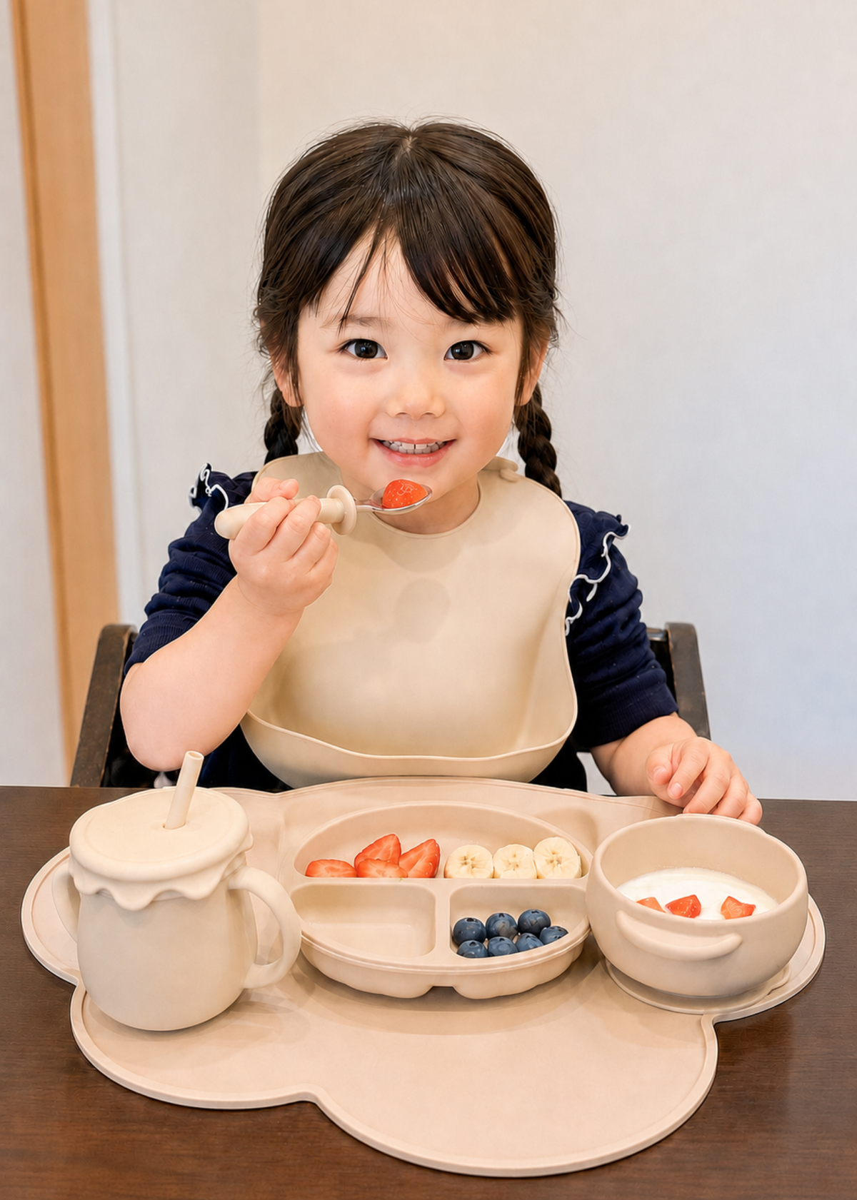 女の子がスプーンを使って食事をしている使用イメージ。子ども用プレートと一緒に使っている食事シーン