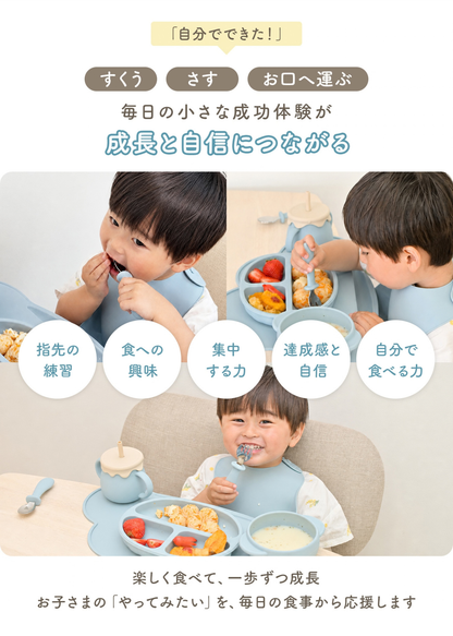 子どもがスプーンとフォークを使って食事をしている使用イメージ。自分で食べる練習をサポートするカトラリー