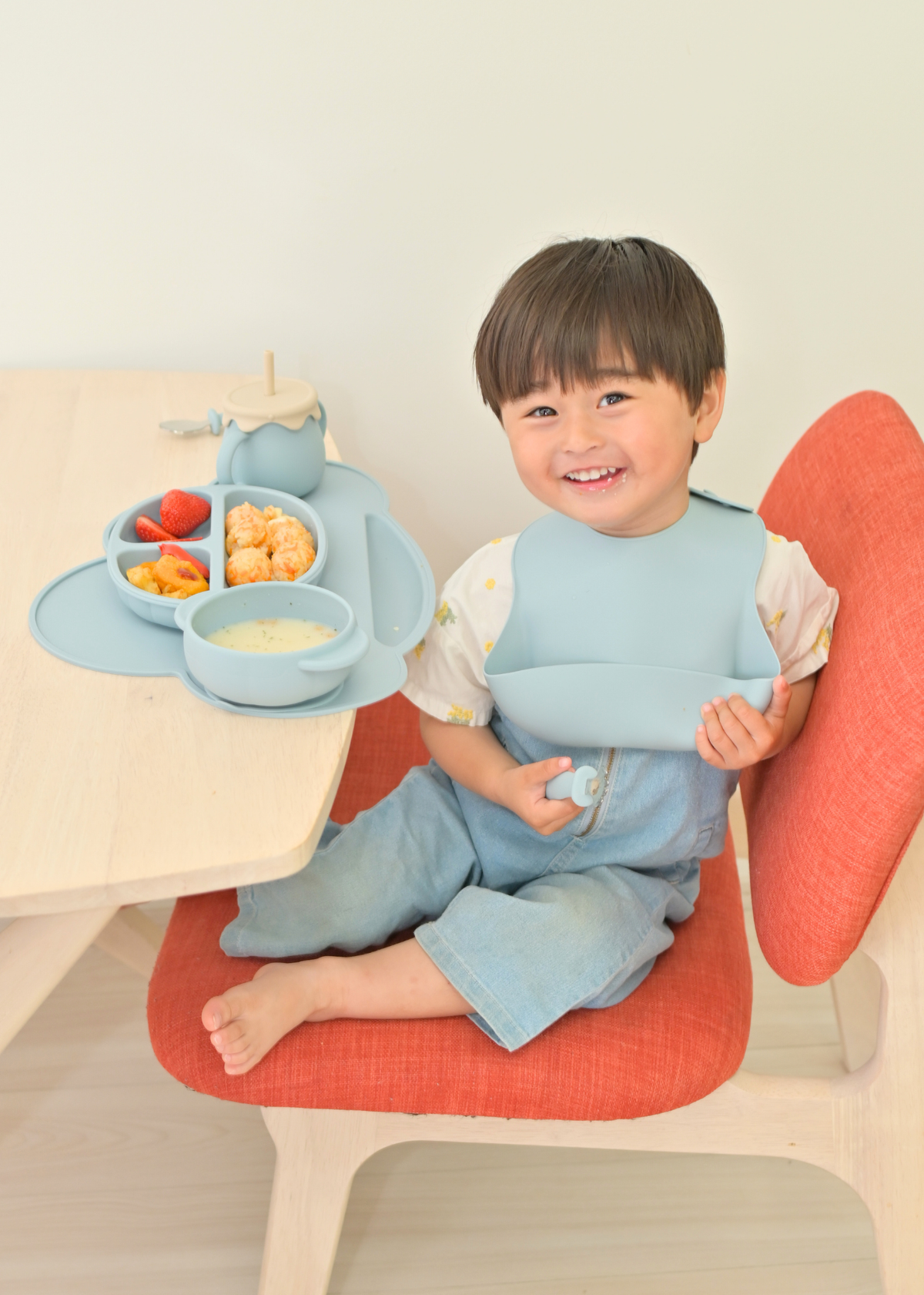 シリコン食器セットを使って子どもがテーブルで食事をしている使用イメージ